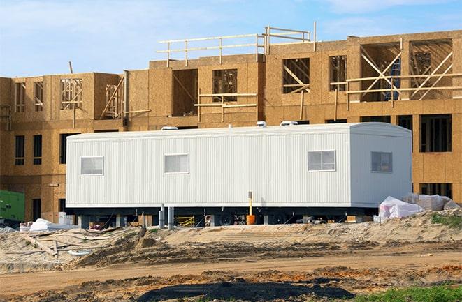 workers studying blueprints in a temporary rental office in Oceanside